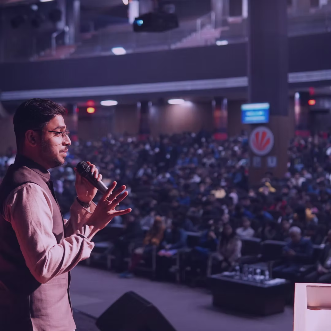 Rumit Walia speaking at a large event